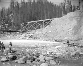 [Men operating monitor at Coquitlam Dam construction site]