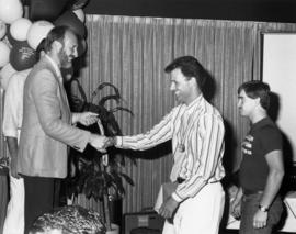 Doctor Tom Waddell handing out medal at 1985 Vancouver Gay and Lesbian Summer Games