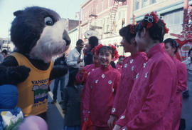 Tillicum interacting with performers at Chinese New Year parade