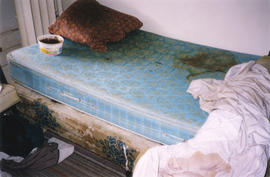Damaged mattress inside Columbia Hotel at 303 Columbia Street