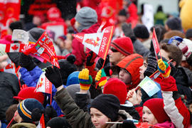 Day 32 Crowd cheer on the flame with their Coke flags at Matane's Community Celebration in Quebec.