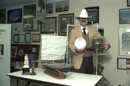 Mike Harcourt posing in a cowboy hat in front of gift display