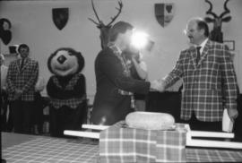 Unidentified man and Mike Harcourt shake hands