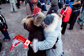 Day 7 onlookers hugging at Community Celebration in Kugluktuk.