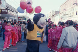 Tillicum interacting with performers at Chinese New Year parade
