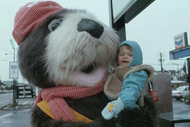 Tillicum carrying toddler at Tremblay and Sons Chevron Station on 4th Avenue and Macdonald Street