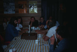 Gathering around dinner table at sculptors' house