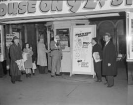 [Man dressed as Santa Claus doing a "Man on the Street" broadcast for C.K.M.O. radio ou...