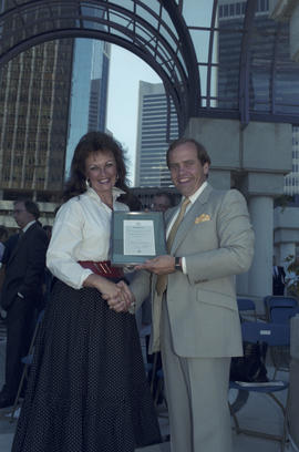 Unidentified woman and man holding framed document at Portal Park opening