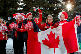 Day 76 Group of women dress in red attire for the flame as it passes in Alberta.