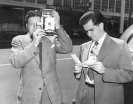 [George Thompson using the first "one a minute" camera in Canada]