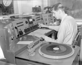 [Man in control room of CKWX radio]