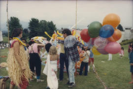 Balloon twisters entertaining group of children