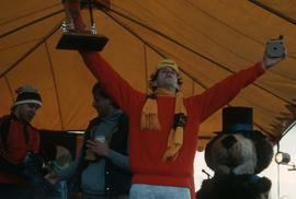 Man holding awards on stage at Polar Bear Swim