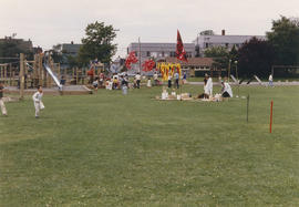 Children and attendees on field at Centennial event