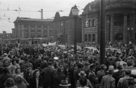 [Crowds at the corner of Main Street and Hastings Street during VJ Day celebrations]