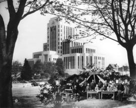 [The new City Hall superimposed with the first City Council in front of a tent]