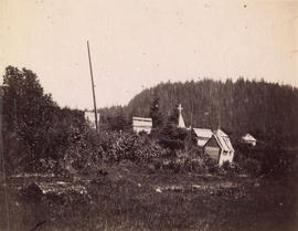 [View of First Nations wooden burial huts]