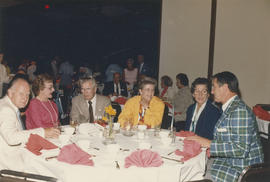 21 Club reunion attendees seated at table in Columbia Room at Hotel Vancouver