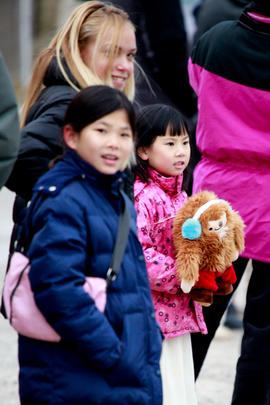 Day 52 Young girl watches the flame pass with Olympic mascot Quatchi in her hands in Ontario.