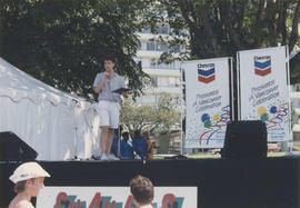 Speaker on Chevron stage at Centennial event