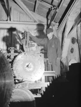 [Man operating a] saw filer