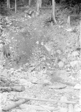 [Men standing among rocks in partially excavated area for Buntzen Lake Power Plant number one]