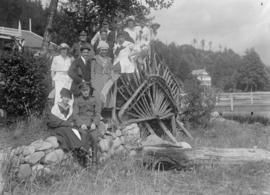 Group posing on a rustic bridge