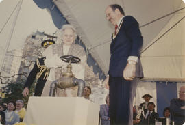 Jeanne Sauvé turning the valve of the Jubilee Fountain with Mayor Harcourt standing beside