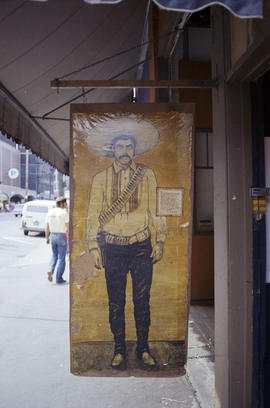 Water Street Signs [Image of man wearing sombrero]