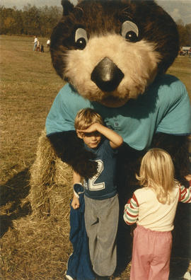 Tillicum interacting with two children in field