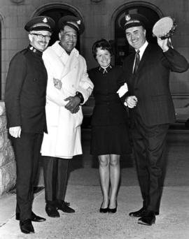 Miss Sally Ann [Mrs. Evelyn Caldwell] of Salvation Army with Robert Bonner holding tambourine and...