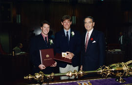 Ross Mcdonald, Eric Jespersen and Mayor Philip Owen pose behind ceremonial mace in council chambers