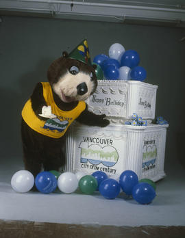 Tillicum standing beside large birthday cake