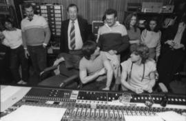 Group behind mixing boards at Griffiths Gibson Productions