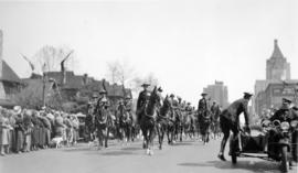 [A parade on Georgia Street travelling west towards Thurlow Street]