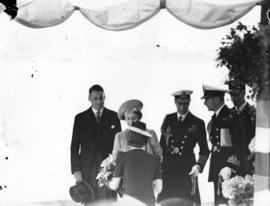 [Queen Elizabeth being presented with a bouquet of flowers]