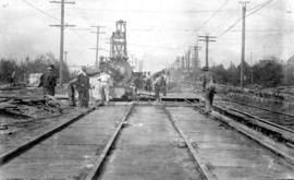 [Men laying] B.C.E.R. tracks - Main St. and 37th Ave.