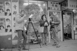 Crew taping outside a shop in Chinatown for the Saltwater City video