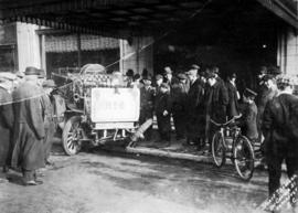 [No. 6 hose wagon with damaged wheel on sidewalk in front of Hudson's Bay Company, Georgia Street]