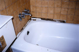 Damaged tile above bathtub inside Balmoral Hotel at 159 East Hastings Street