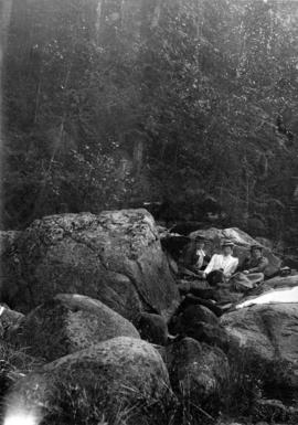 Three women on bank of river