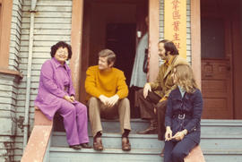 Group sitting on front steps S.P.O.T.A. building