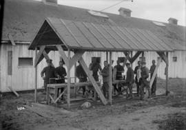 [Soldiers washing up at outdoor sink]