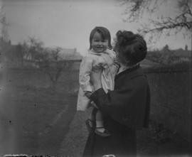 Woman standing outside holding a little girl
