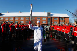 Day 40 Military salute as Torchbearer 96 Martin Gilbert carries the flame into Châteauguay, Quebe...