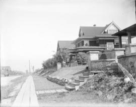 [Unidentified street with wooden sidewalk]