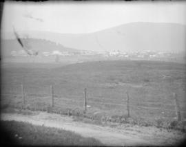 Open landscape with buildings in the background