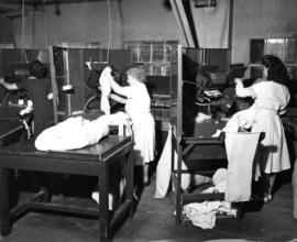 Nelson's Laundry staff pressing shirts on Fantom Fast machines