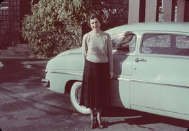 Antoinette Bentley standing in front of blue automobile